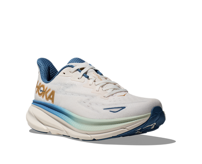 Hoka M Clifton 9 FTG - Vit med blåa och guld detaljer.